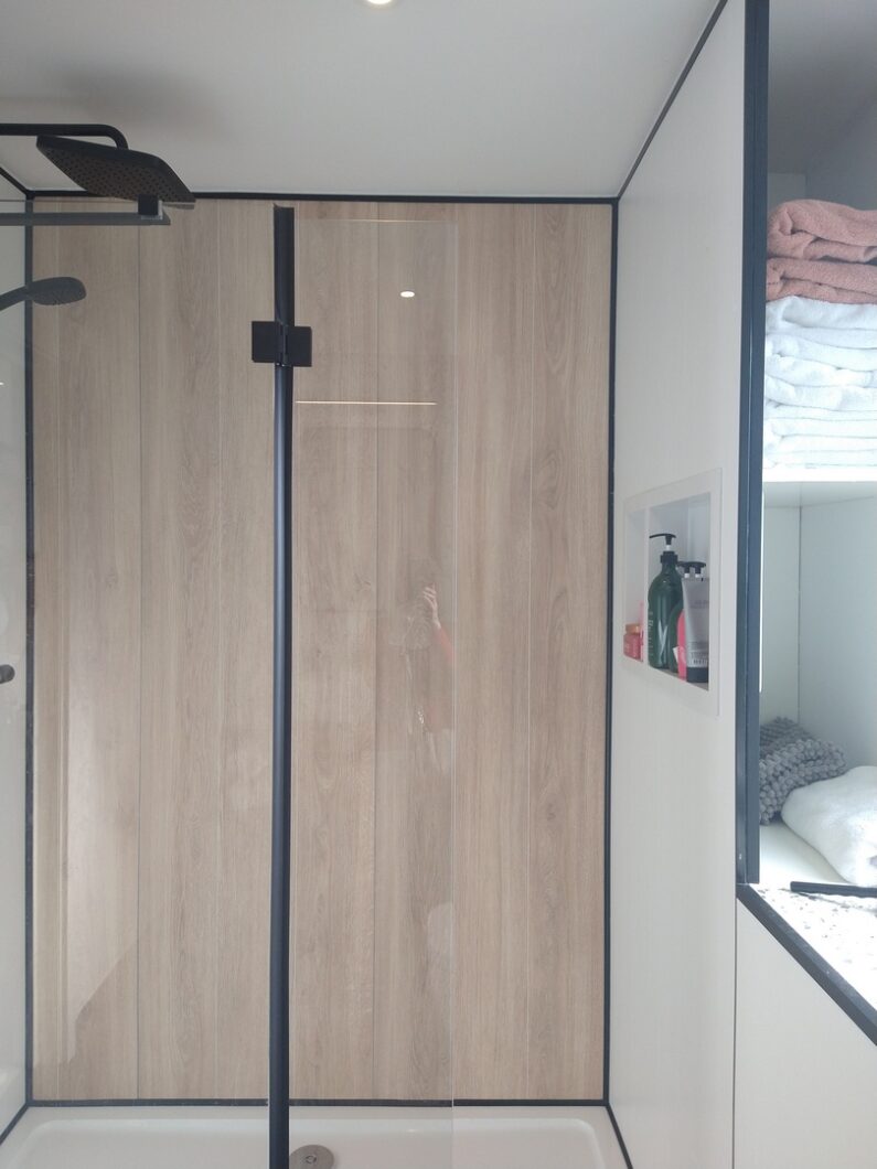 The Bathroom Storage includes hidden towel shelves behind the large Walk-in shower